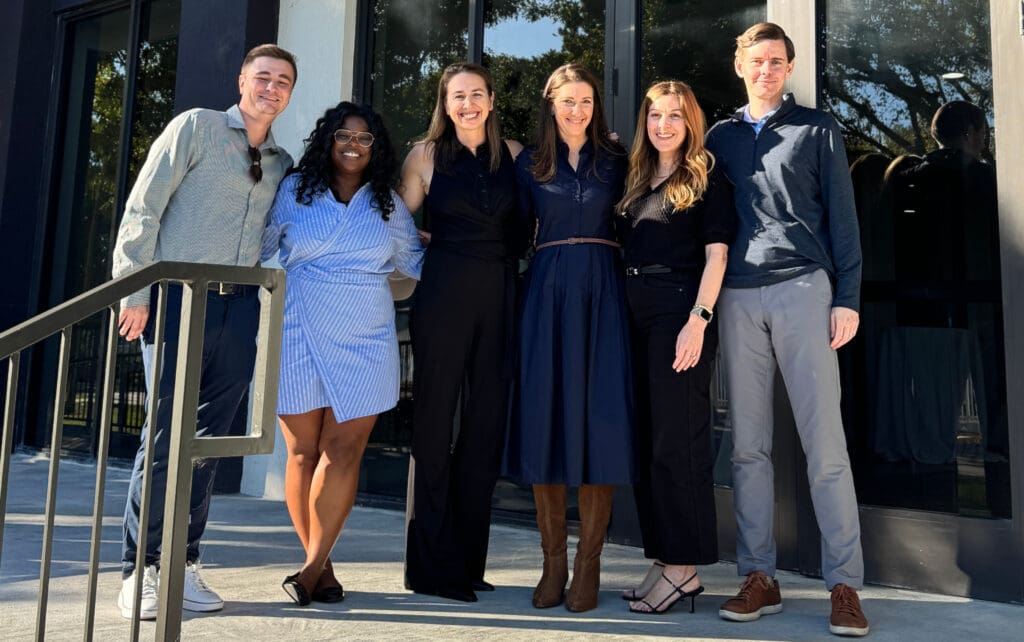 Six members of the MRK team stand outside Sol Vista at the grand opening.